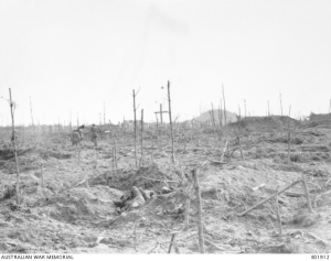 Stretcher bearers of the 57th Battalion, passing through the cemetery near the mound in Polygon Wood in the Ypres Sector. 28 September 1917. Photo: Unknown Australian Official Photographer. Image: Australian War Memorial E01912